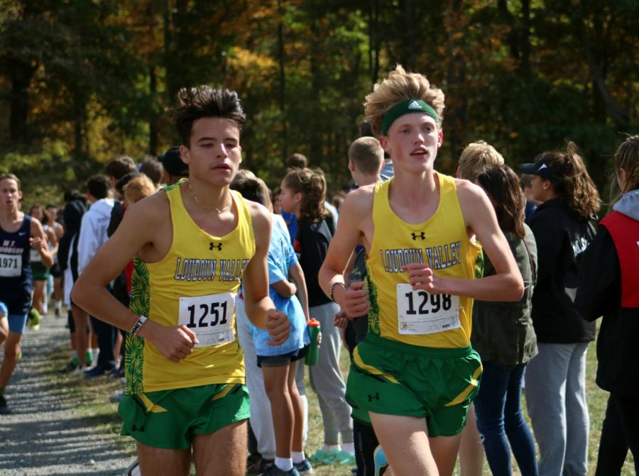 Christian Arellano (left) and Josh Walker (right) run side by side, as they run at the front of the pack, competing in the varsity boys race, at Third Battle. 