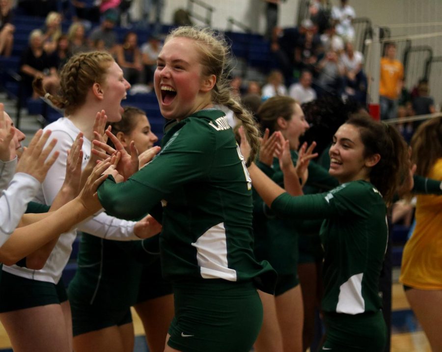 Senior Nicole Steigerwald, high fives all her volleyball teammates, as they beat Woodgrove in a clean sweep on September 12th. 