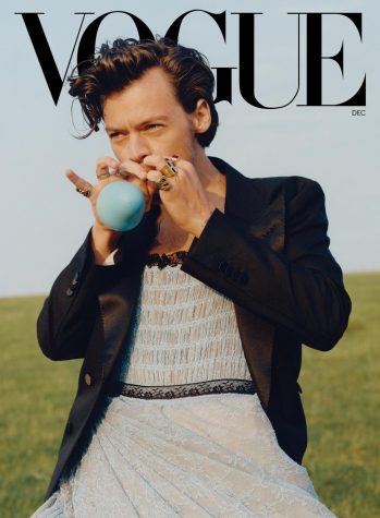 Singer Harry Styles poses on the cover of the December issue of Vogue in a dress, defying clothings gender norms. Photo | Vogue
