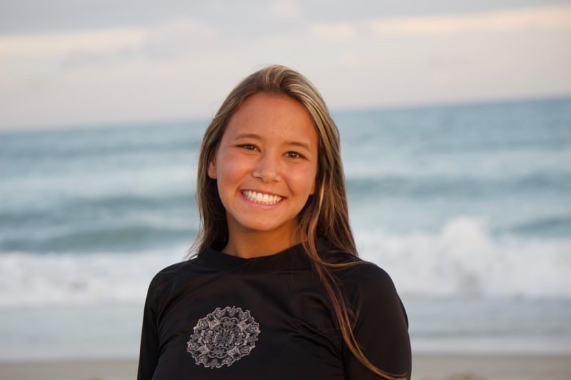 Carleigh smiles as she hits the beach for a sunset surf session.