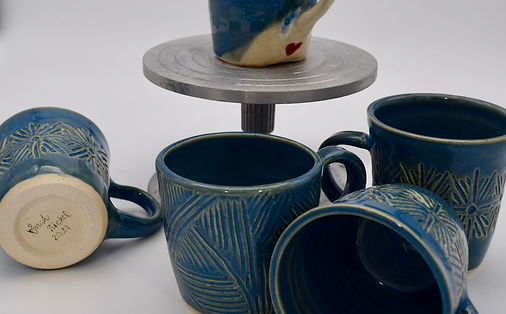 These hand-crafted mugs are a few of the many beautiful works of pottery created by Sarah Nickel. 
