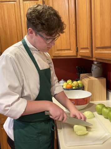 In his kitchen, Nutzman cuts apples to bake a pie for his friend. 