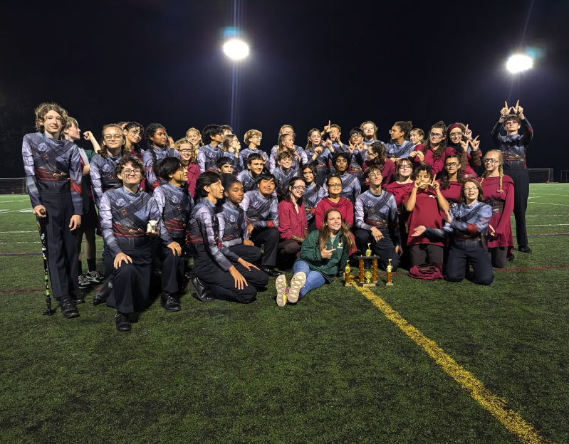 LVHS Marching Band with trophy after placing first in Music and Percussion sections