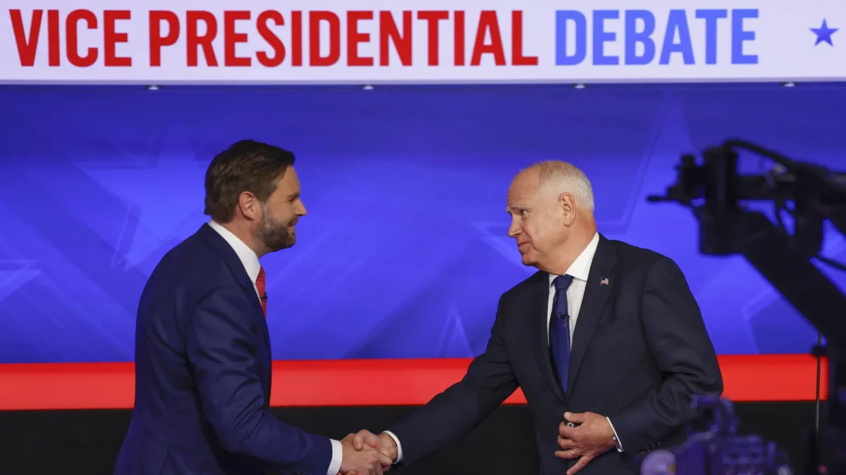 Ohio Senator JD Vance (R) and Minnesota Governor Tim Walz (D) shake hands before beginning the debate.