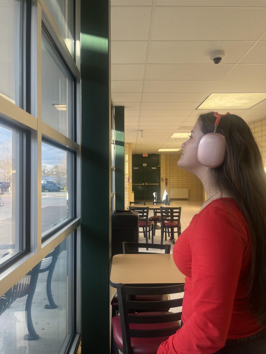 Charlotte Reason looking out the window while listening to music