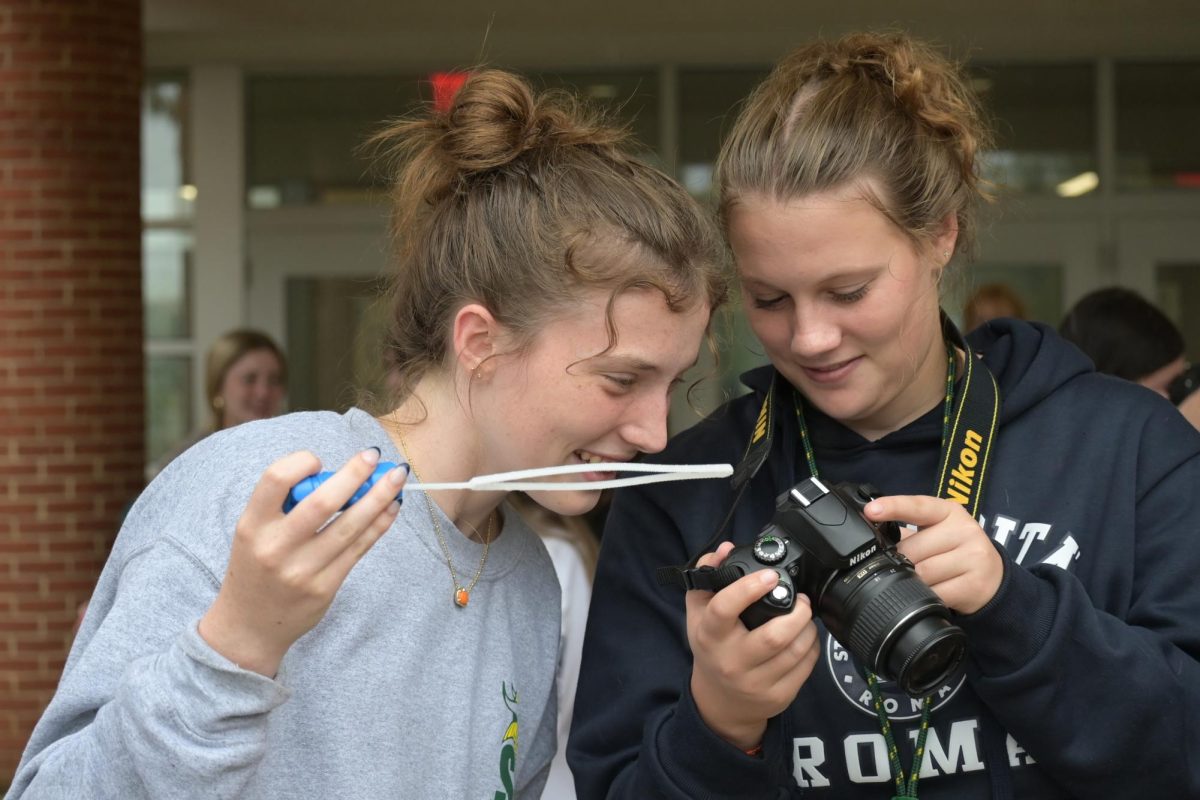 Staff photographers Claire O'Connor and Avery Ramsey take photos at photo workshop, Sept. 25, 2024