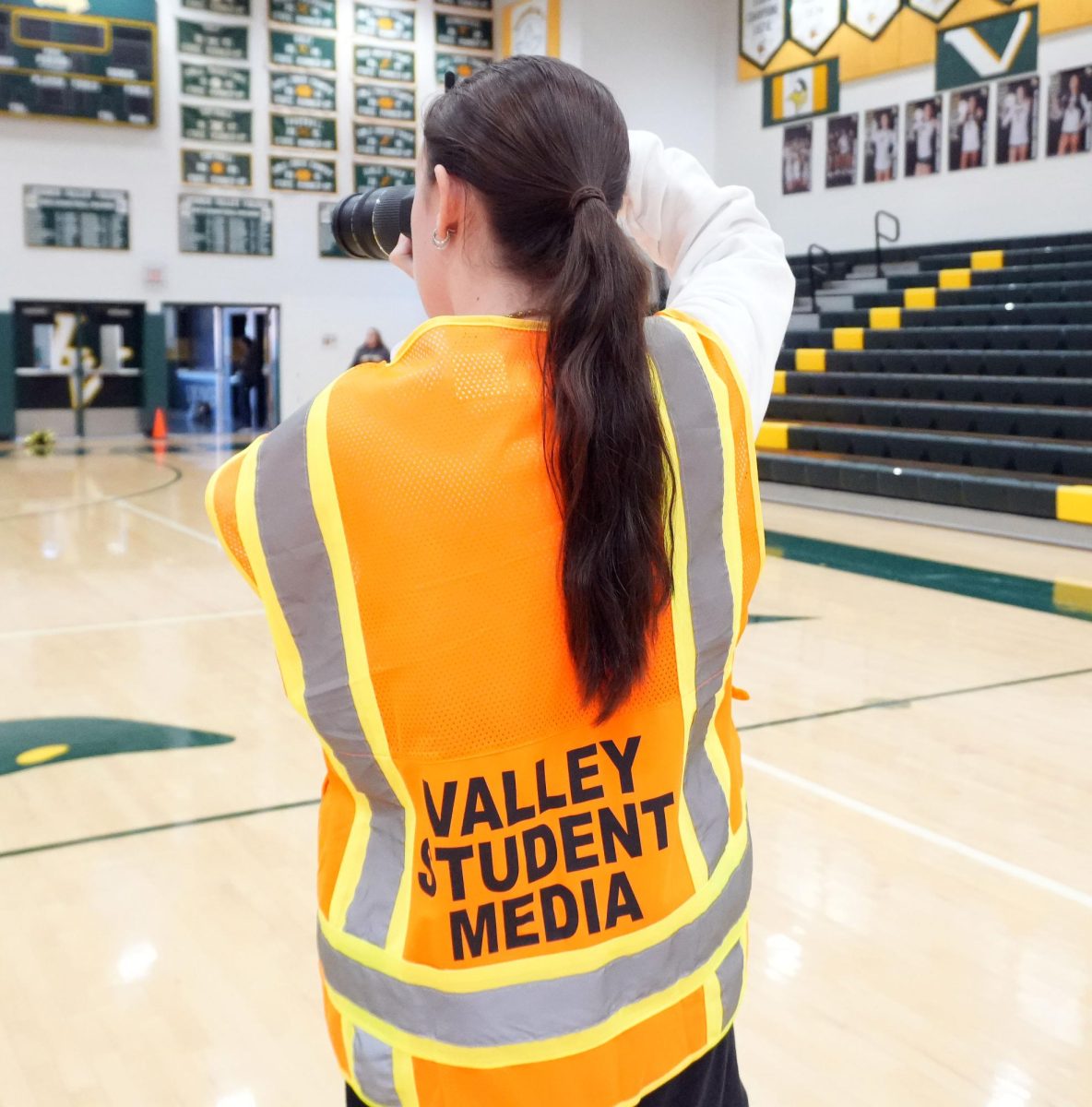Kenzie Champney takes photo at HOCO pep rally for the yearbook